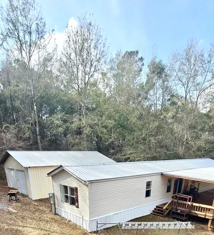 a view of a white house with a yard