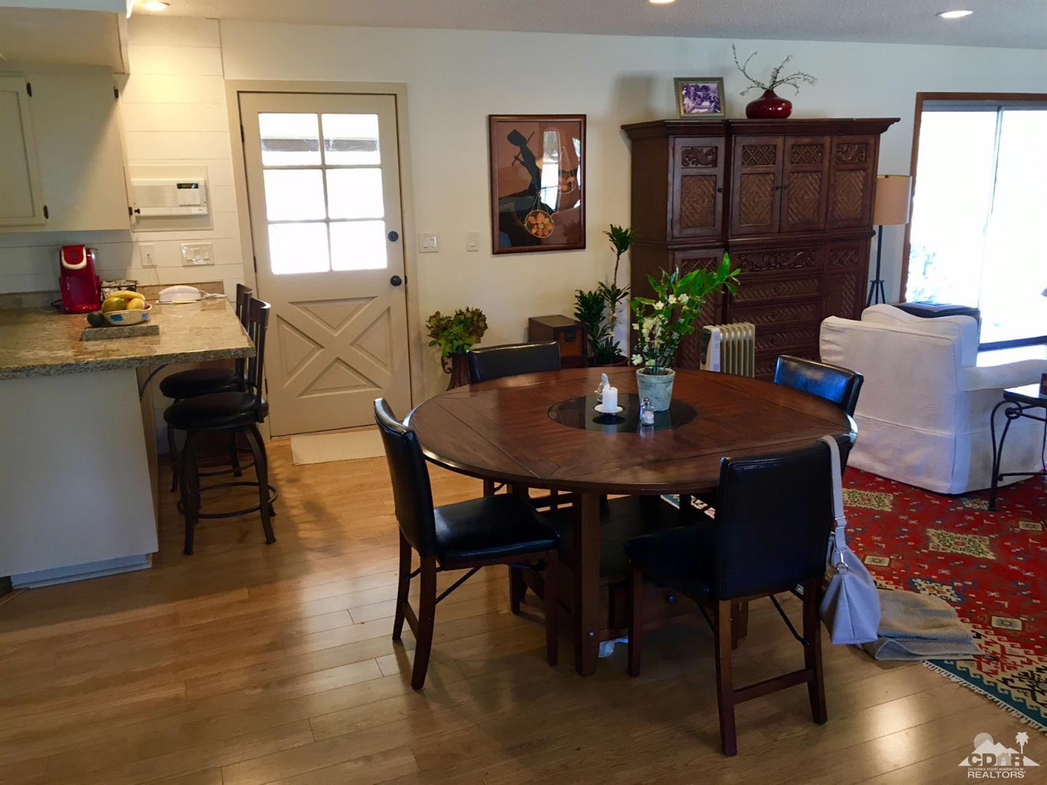 35280 Tool Box Spring Road Mountain Center, CA 92561 - Photo 11 of 29 a view of a dining room with furniture and wooden floor