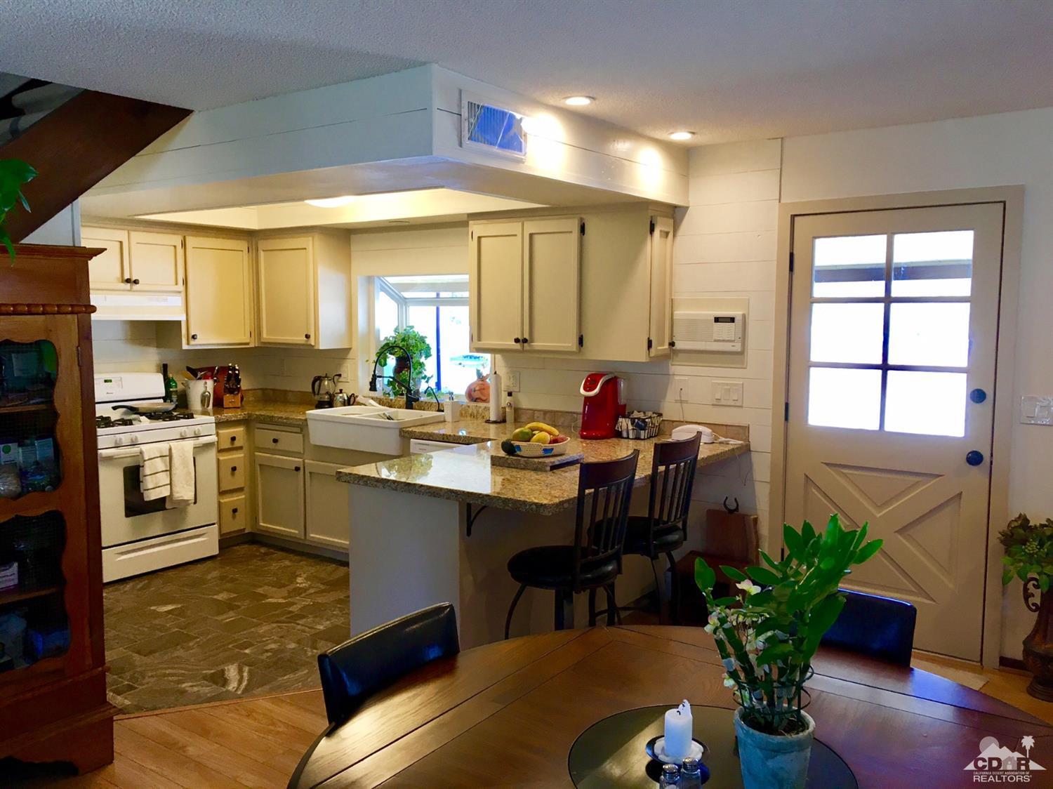 35280 Tool Box Spring Road Mountain Center, CA 92561 - Photo 12 of 29 a kitchen with a table chairs sink and cabinets