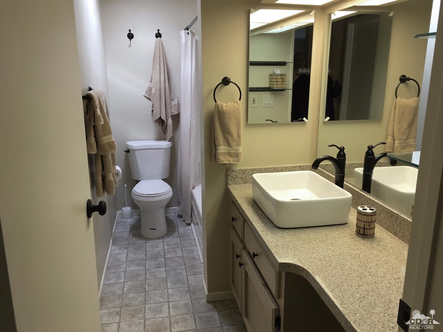 35280 Tool Box Spring Road Mountain Center, CA 92561 - Photo 17 of 29 a bathroom with a granite countertop sink a toilet and a mirror