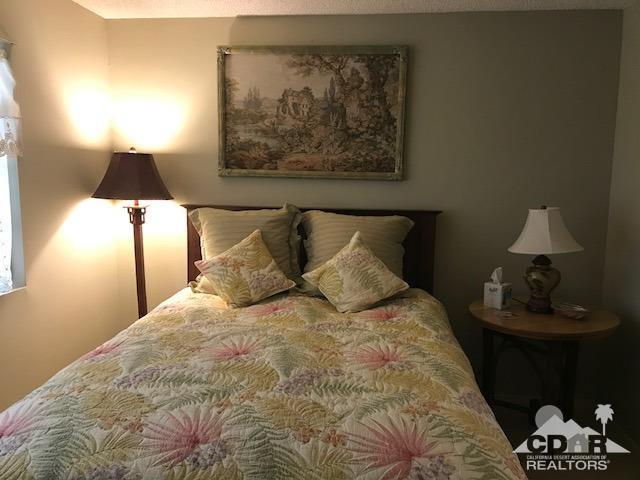 35280 Tool Box Spring Road Mountain Center, CA 92561 - Photo 18 of 29 a large bed sitting in a bedroom next to a lamp