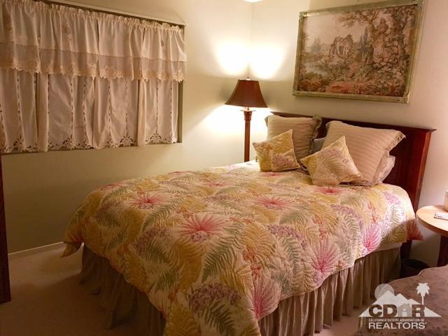 35280 Tool Box Spring Road Mountain Center, CA 92561 - Photo 19 of 29 a bed sitting in a bedroom next to a lamp
