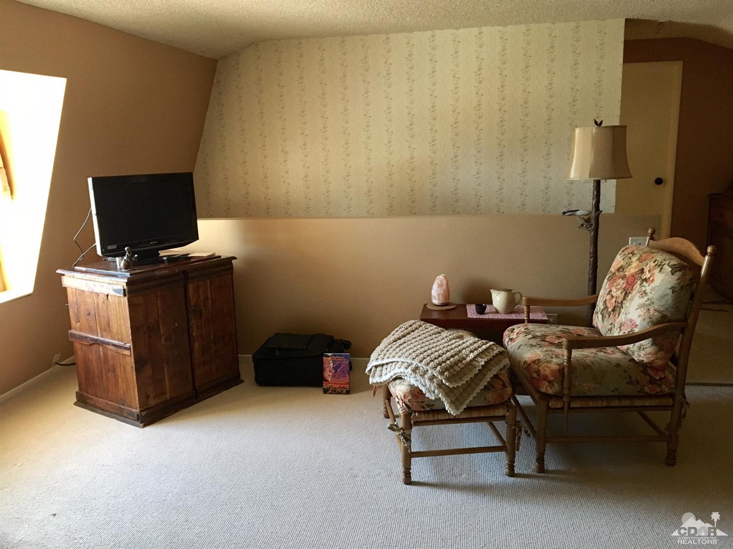 35280 Tool Box Spring Road Mountain Center, CA 92561 - Photo 22 of 29 a bedroom with a bed and chair