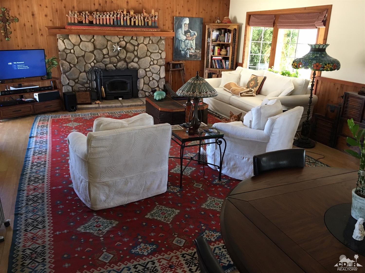 35280 Tool Box Spring Road Mountain Center, CA 92561 - Photo 10 of 29 a living room with furniture a fireplace and a table