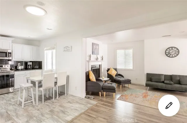a living room with furniture a rug and white appliances