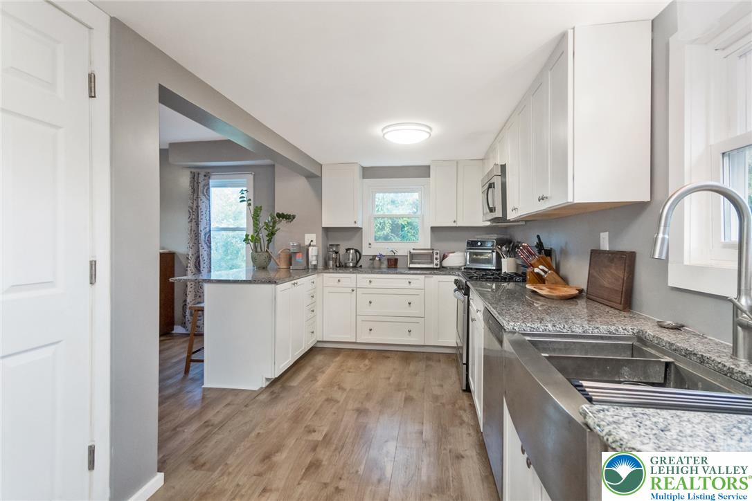 506 Richmond Road Bangor, PA 18013 - Photo 12 of 43 Polished quartz countertops and classic wood-look flooring define this functional kitchen space.