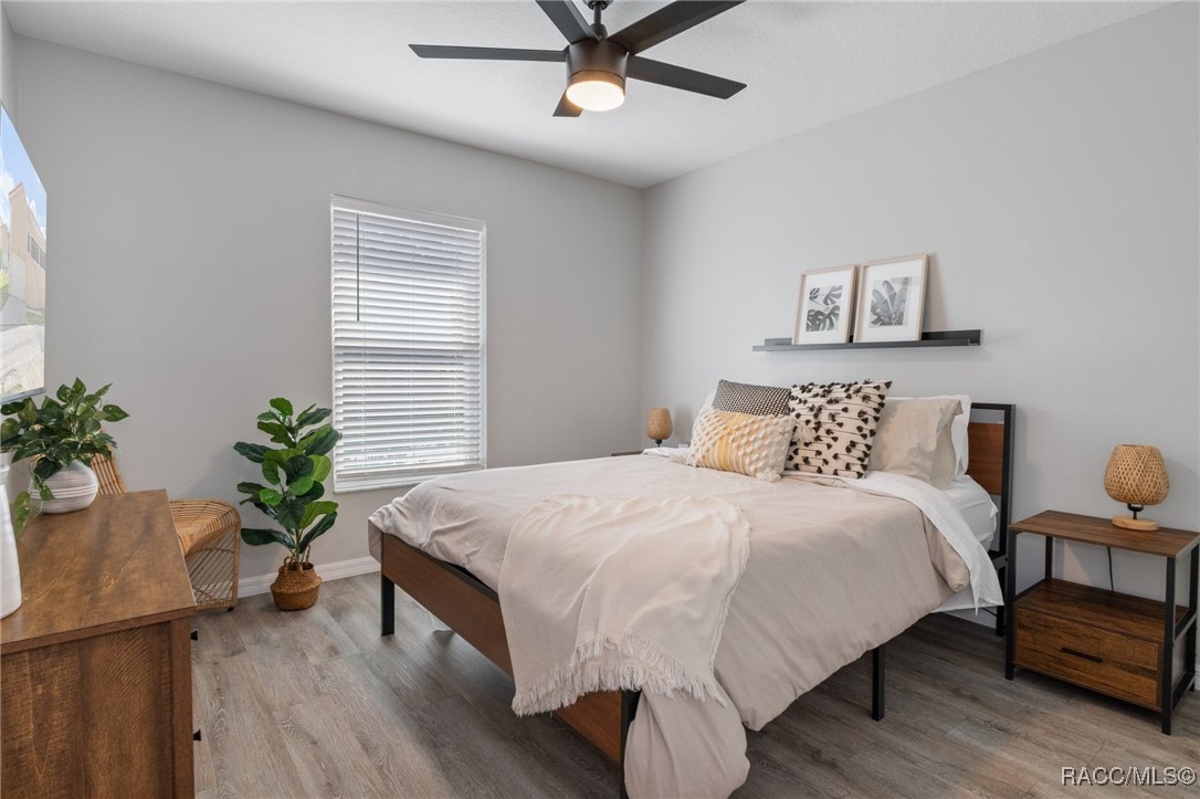 4865 South Tromp Loop Homosassa, FL 34448 - Photo 17 of 30 a bedroom with a bed and a potted plant