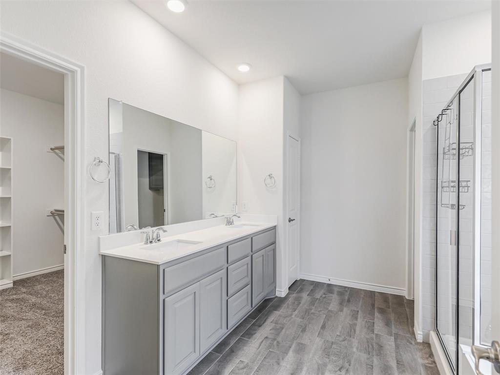 3024 Meredith Lane Forney, TX 75126 - Photo 14 of 29 Bathroom featuring a dual vanity with a light gray cabinet, white countertop, and two undermount sinks