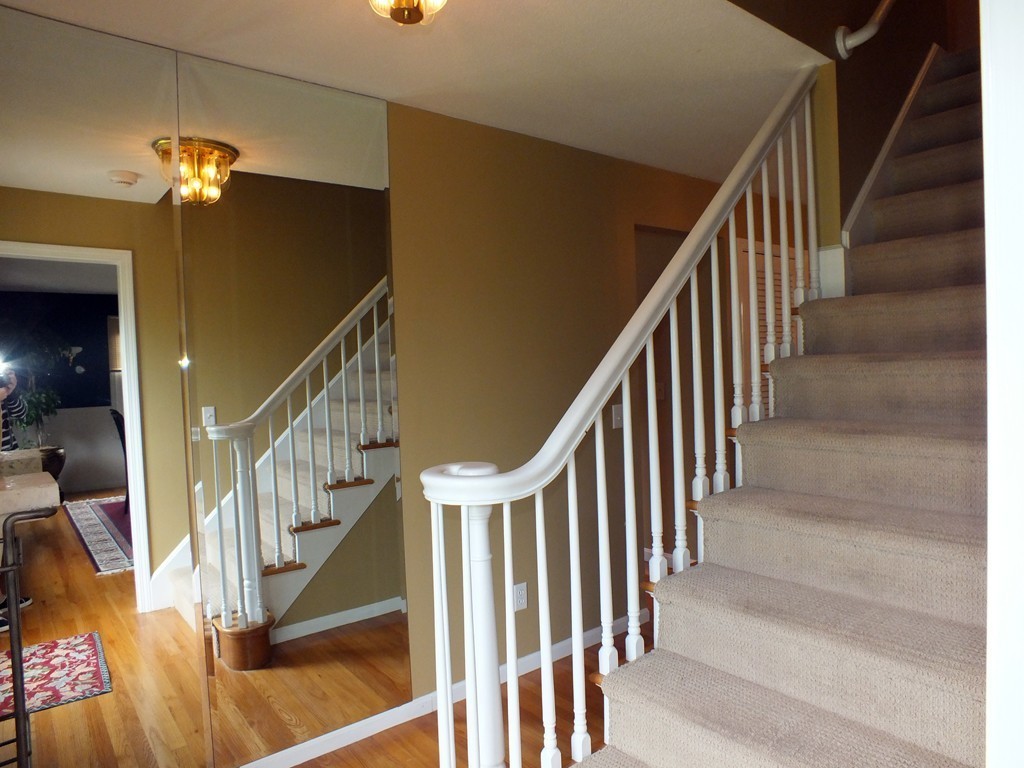 17 Orchard Road East Longmeadow, MA 01028 - Photo 6 of 30 a view of staircase with lots of frames on wall and wooden floor