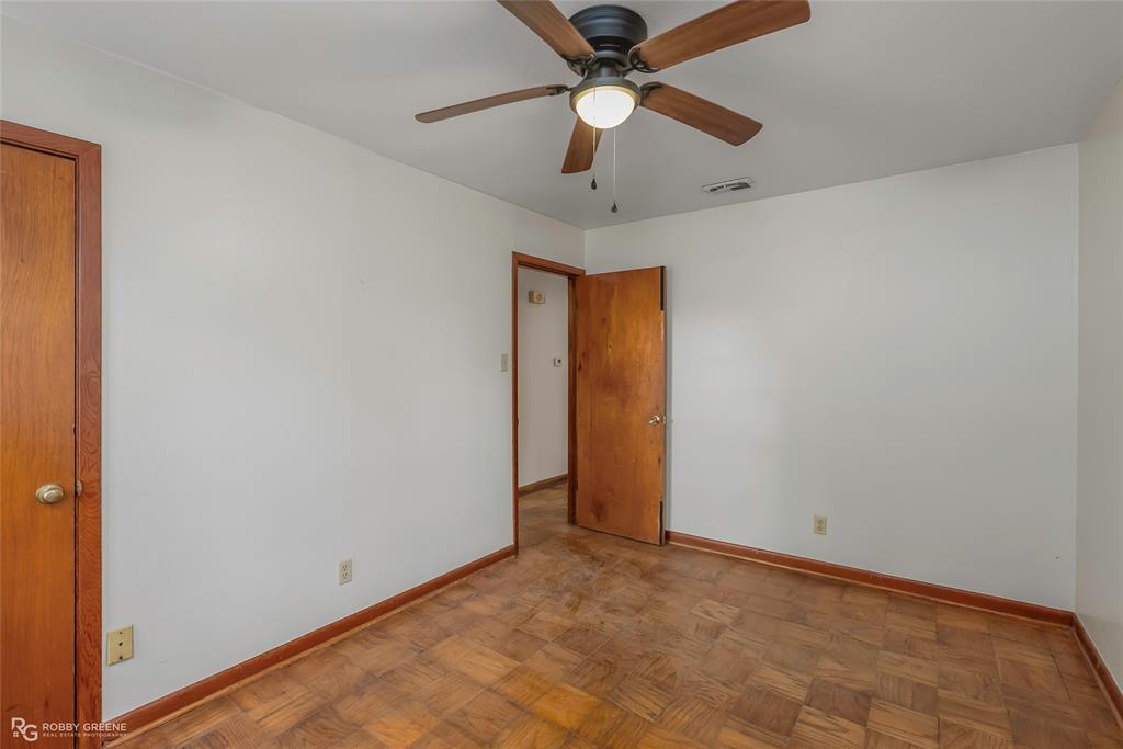 8321 Kingston Road Shreveport, LA 71108 - Photo 16 of 22 an empty room with a ceiling fan and carpet