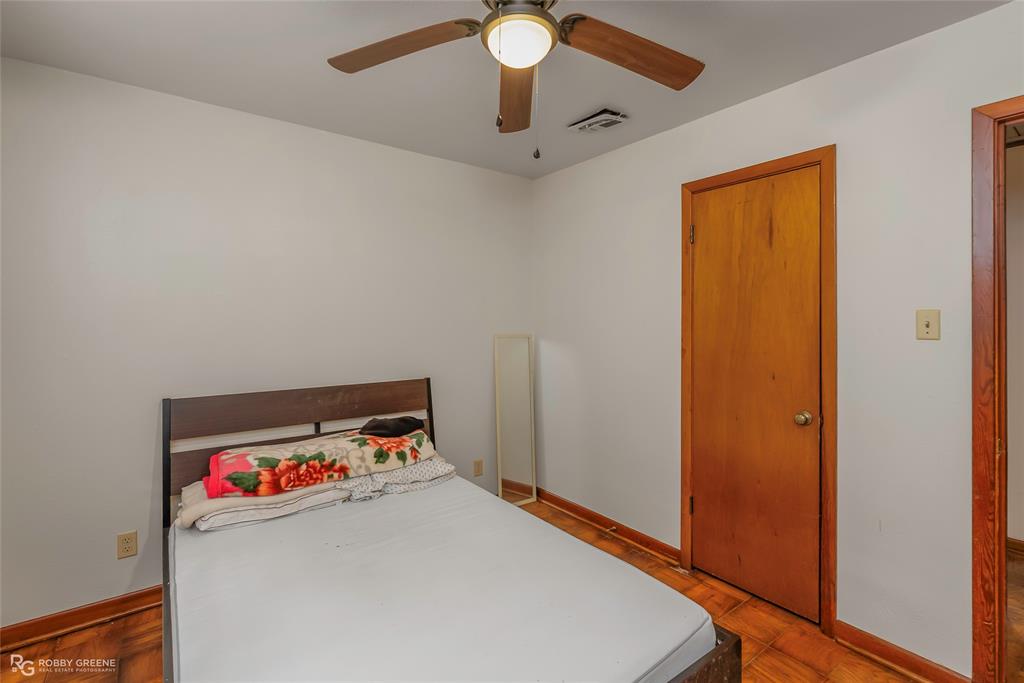 8321 Kingston Road Shreveport, LA 71108 - Photo 18 of 22 a room with a bed and a chandelier