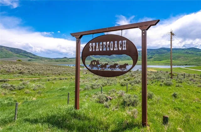 a sign of golf club on a wall under a blue umbrella
