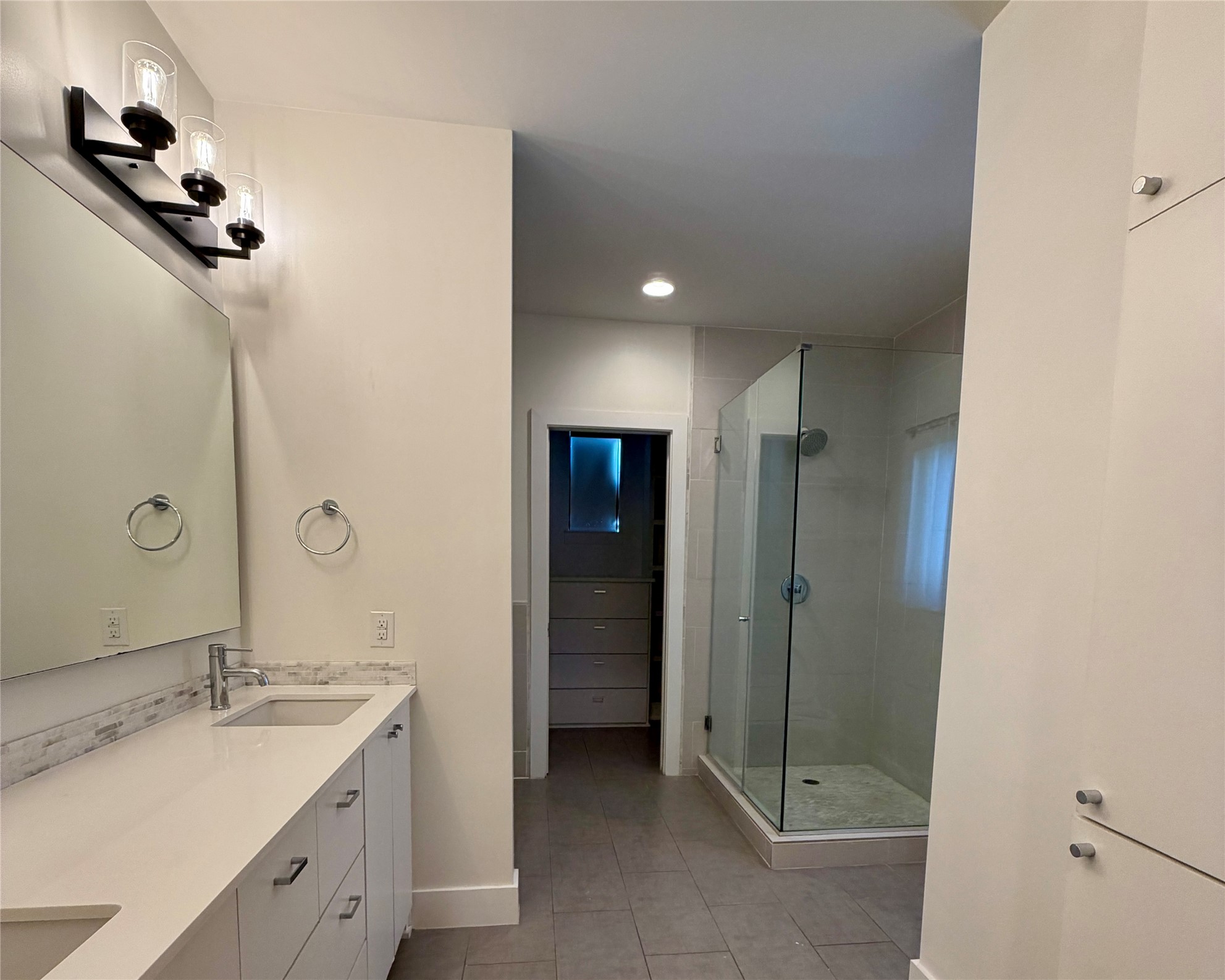 1515 Hether Street, Unit B Austin, TX 78704 - Photo 12 of 30 A well-lit bathroom showcases a spacious walk-in shower and dual vanities.
