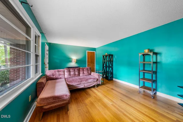 a kitchen with stainless steel appliances a dining table chairs stove and cabinets