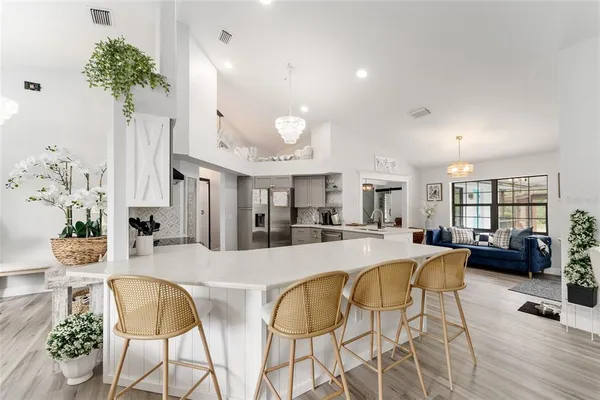a living room with fireplace furniture and a potted plant