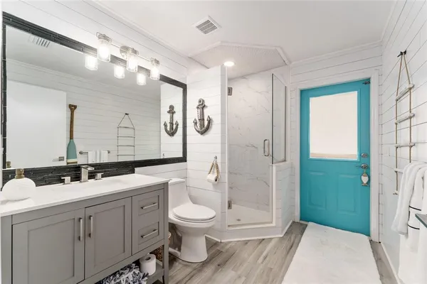 a bathroom with a toilet sink and shower