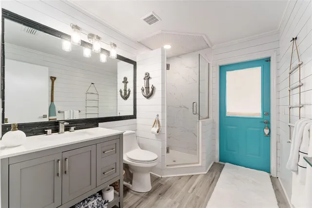 a bathroom with a toilet sink and shower