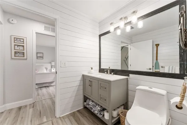 a bathroom with a sink a toilet and mirror