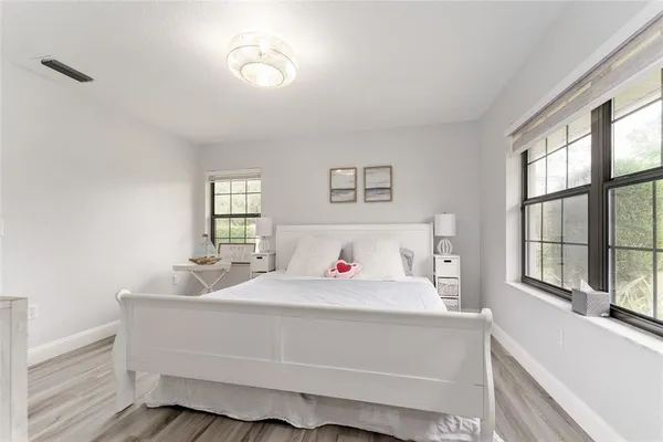 a bedroom with a bed and a large window