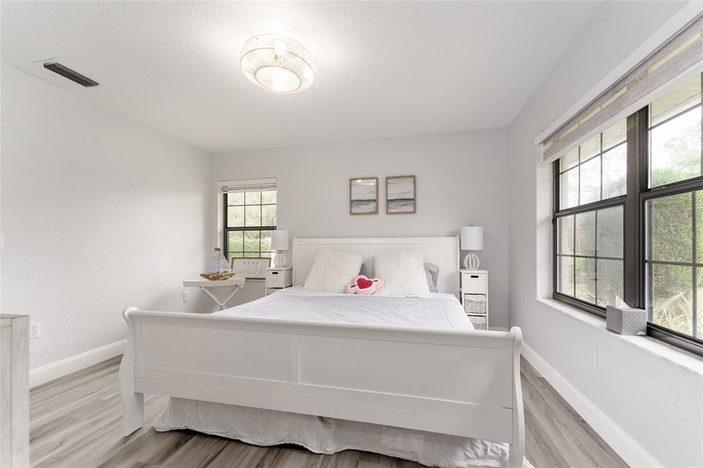 4841 Northwest 76th Court Ocala, FL 34482 - Photo 20 of 40 a bedroom with a bed and a large window