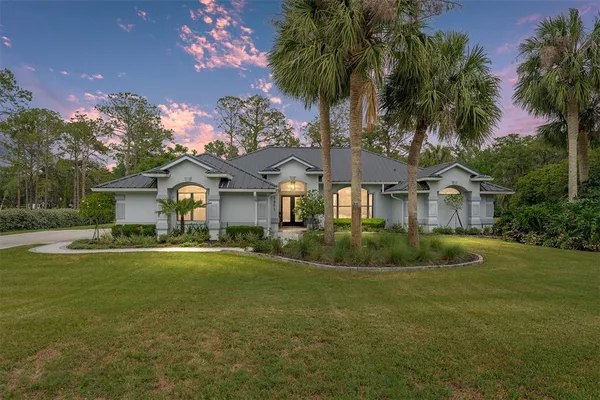 a front view of house with yard and green space