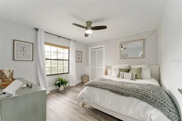 a bedroom with a bed and a chandelier