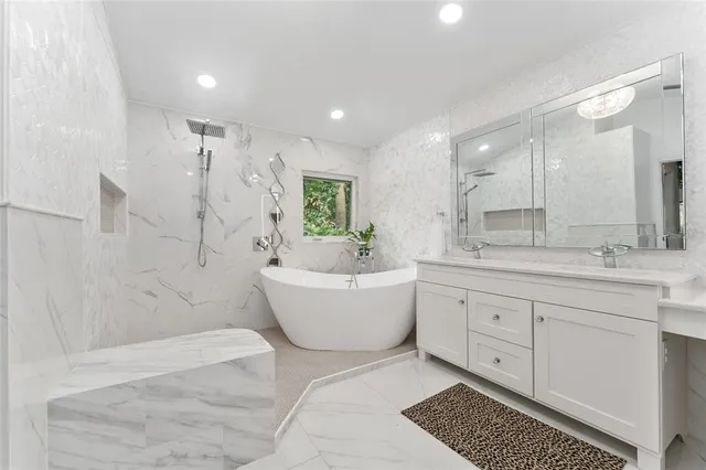 a spacious bathroom with a double vanity sink a mirror and a bathtub