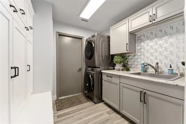 a bathroom with a sink a mirror a washer and dryer
