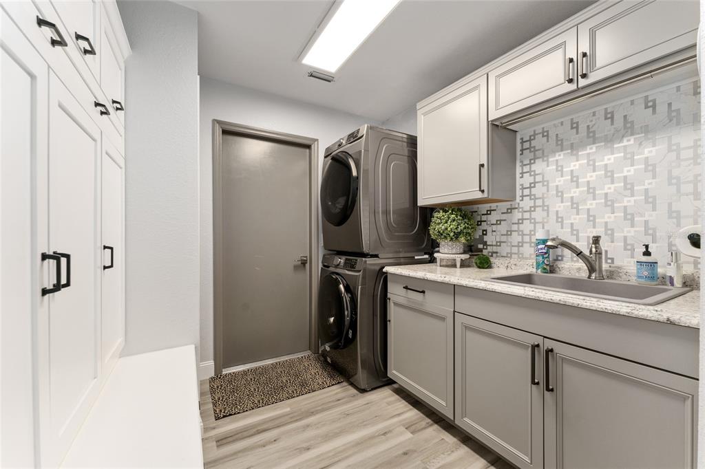 4841 Northwest 76th Court Ocala, FL 34482 - Photo 25 of 40 a bathroom with a sink a mirror a washer and dryer