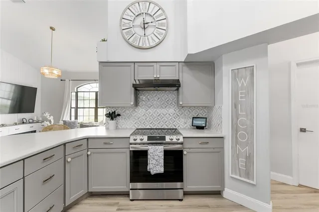 a kitchen with a stove oven and a clock