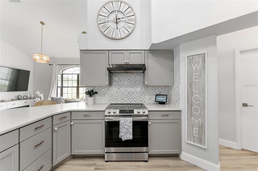 4841 Northwest 76th Court Ocala, FL 34482 - Photo 8 of 40 a kitchen with a stove oven and a clock