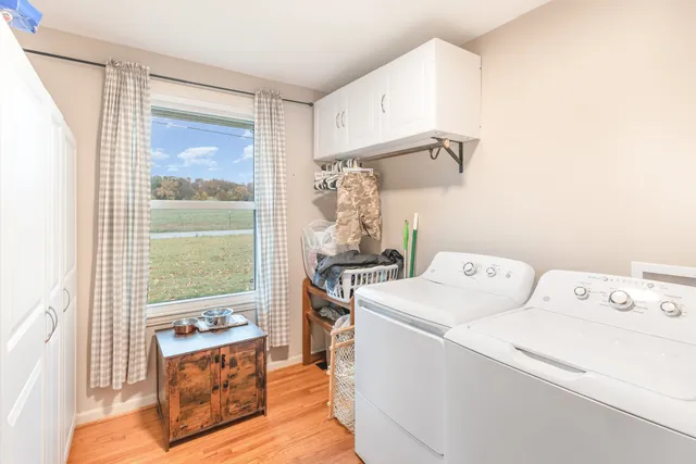 a view of washer and dryer with kitchen in the background