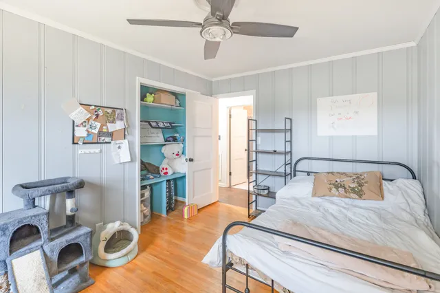 a bedroom with furniture and a wooden floor