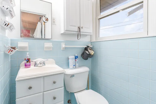 a bathroom with a sink toilet and a mirror
