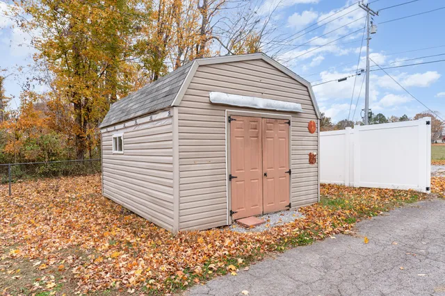 a view of a white house with a yard and garage