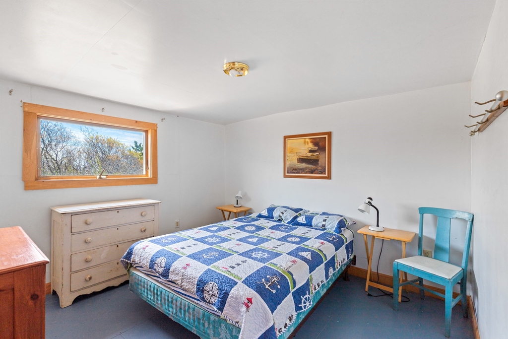 0 Bayberry Hill Road Cuttyhunk, MA 02713 - Photo 8 of 12 a bedroom with a bed and a table
