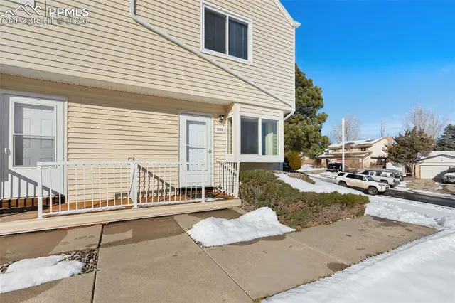 a view of a house with a backyard and sitting area