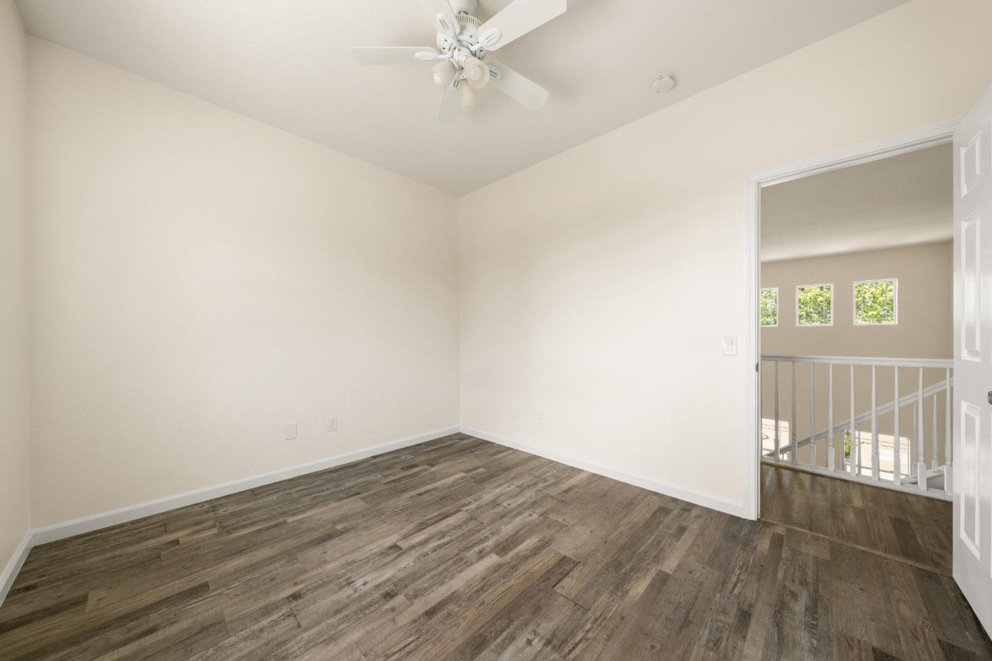 5700 Gold Poppy Way Elk Grove, CA 95757 - Photo 13 of 49 an empty room with wooden floor and windows