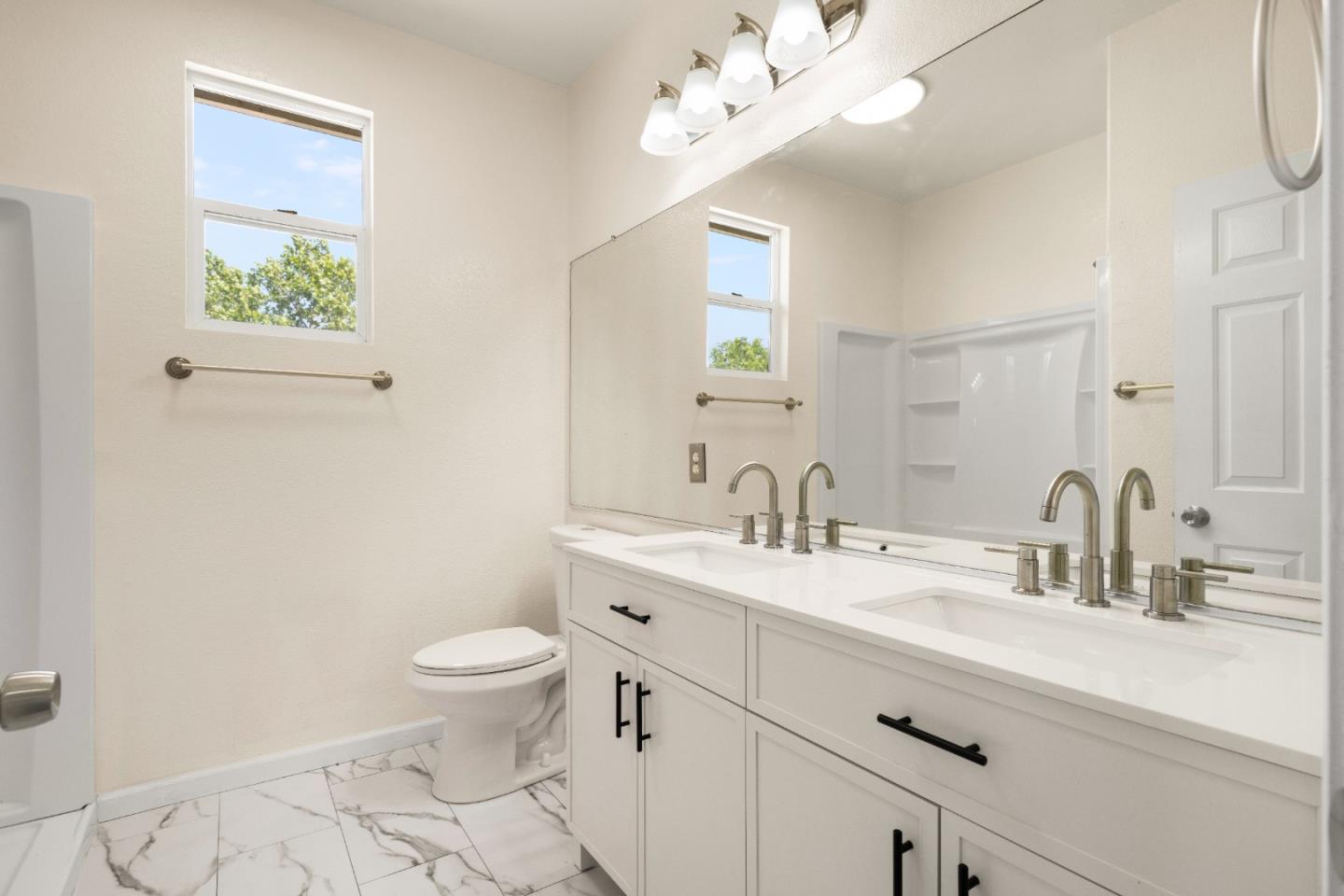 5700 Gold Poppy Way Elk Grove, CA 95757 - Photo 15 of 49 a bathroom with a toilet a sink and mirror