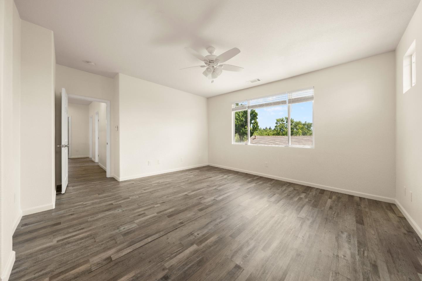 5700 Gold Poppy Way Elk Grove, CA 95757 - Photo 19 of 49 an empty room with wooden floor ceiling fan and windows