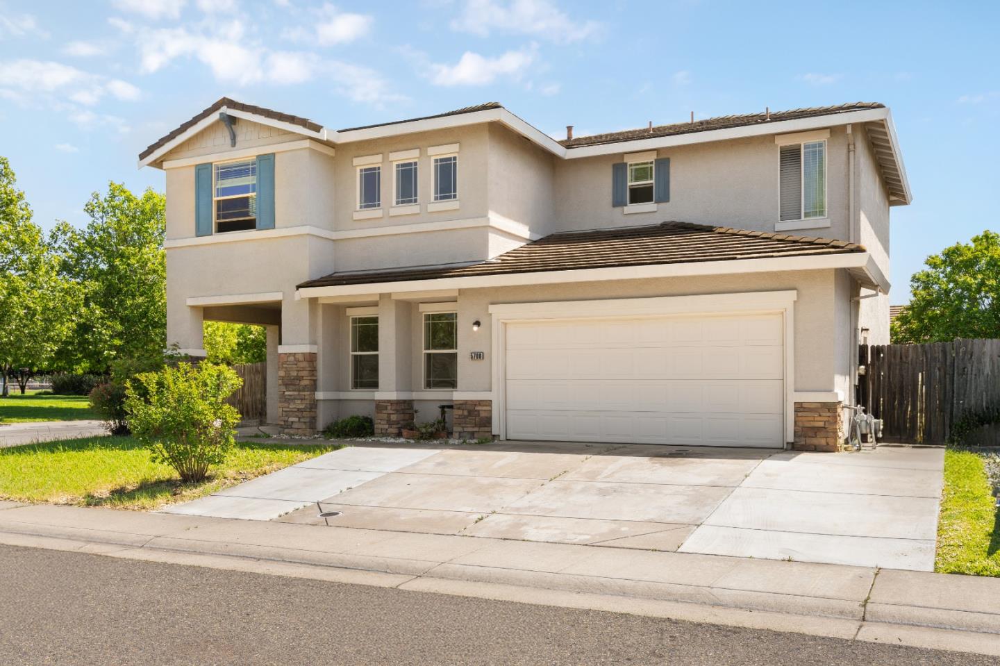 5700 Gold Poppy Way Elk Grove, CA 95757 - Photo 2 of 49 a front view of a house with yard