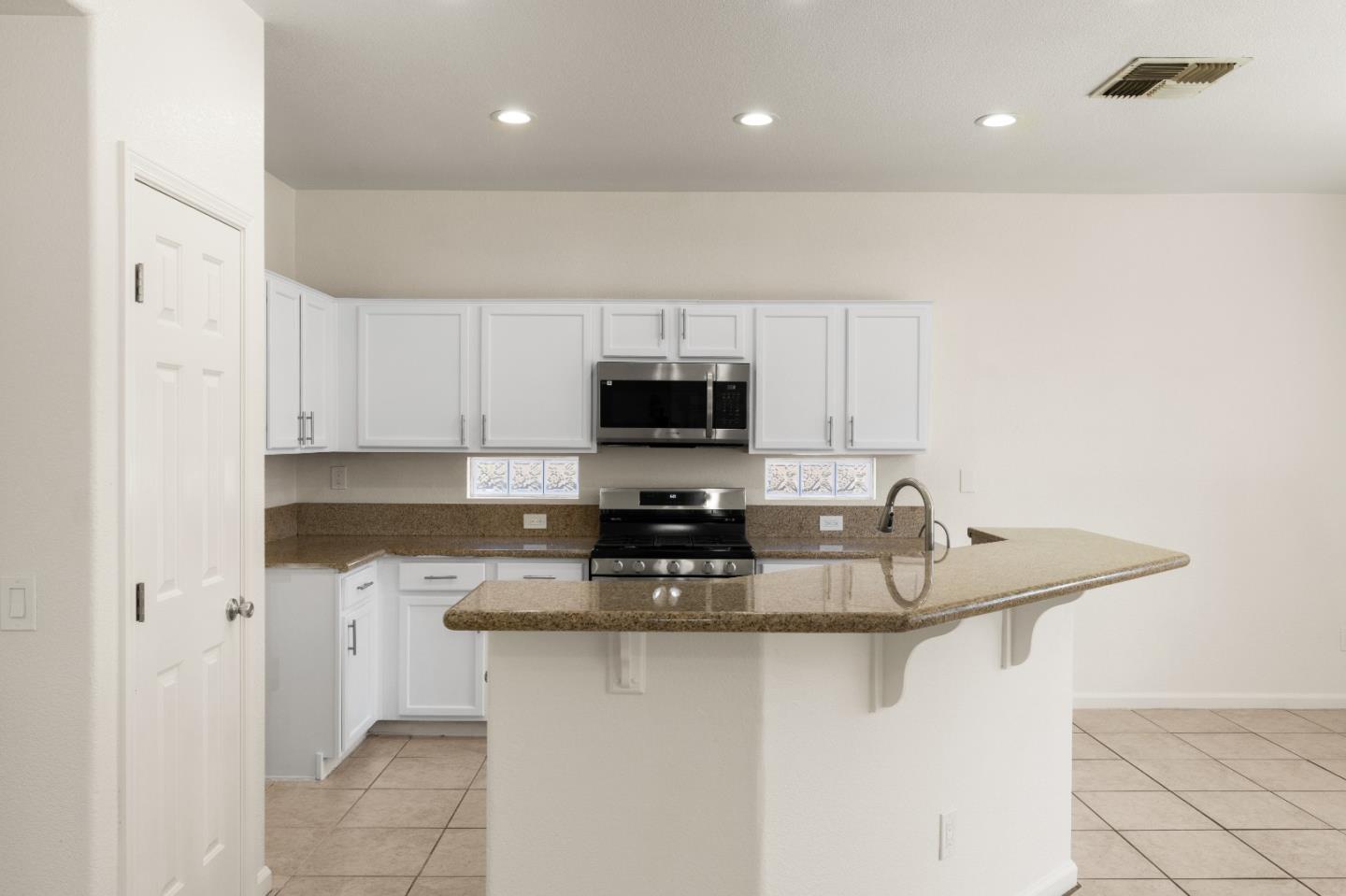 5700 Gold Poppy Way Elk Grove, CA 95757 - Photo 23 of 49 a kitchen with stainless steel appliances granite countertop a sink a stove and a refrigerator