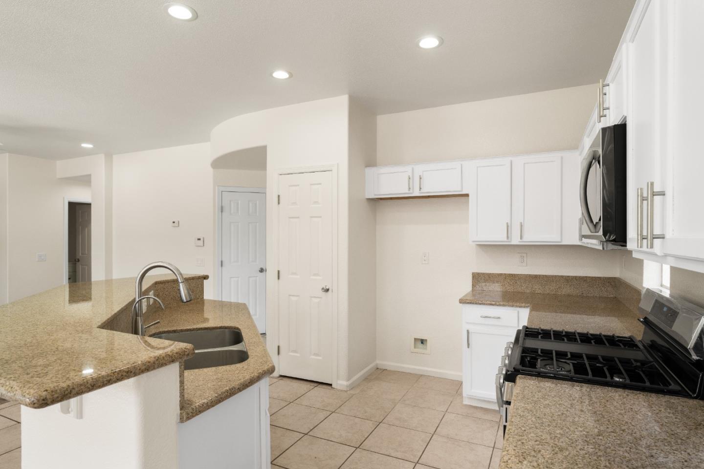 5700 Gold Poppy Way Elk Grove, CA 95757 - Photo 24 of 49 a kitchen that has a sink and a stove