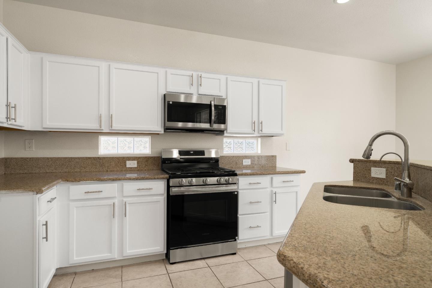 5700 Gold Poppy Way Elk Grove, CA 95757 - Photo 28 of 49 a kitchen with white cabinets and appliances
