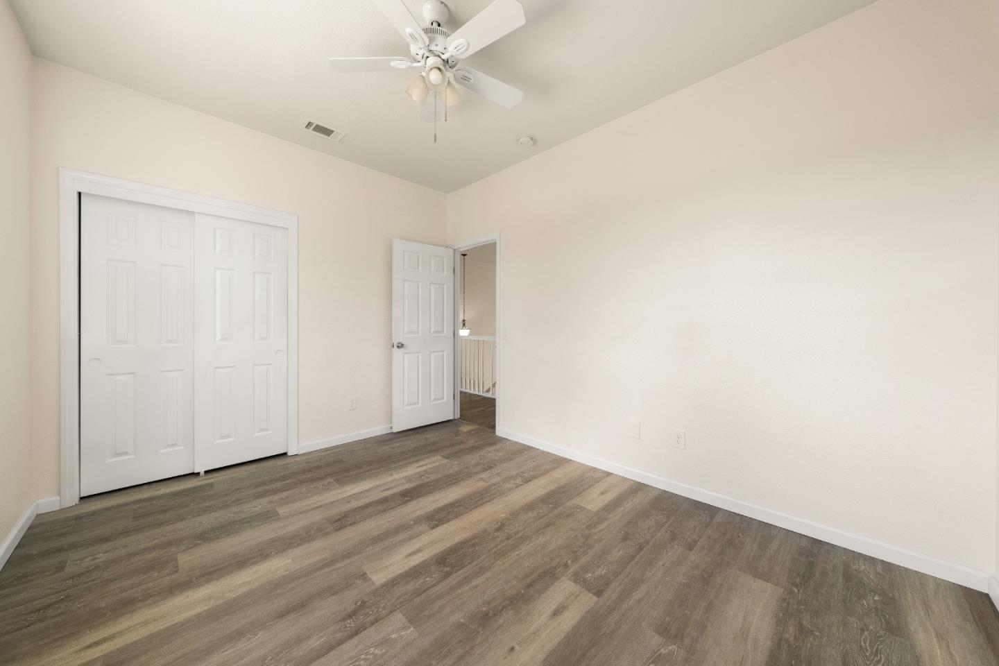 5700 Gold Poppy Way Elk Grove, CA 95757 - Photo 35 of 49 an empty room with a ceiling fan and wooden floor
