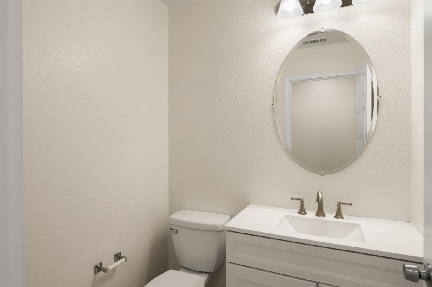 5700 Gold Poppy Way Elk Grove, CA 95757 - Photo 36 of 49 a bathroom with a toilet a sink and mirror