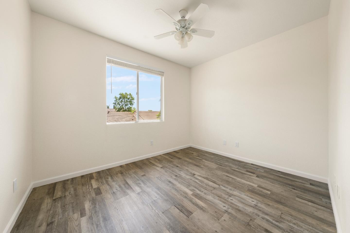 5700 Gold Poppy Way Elk Grove, CA 95757 - Photo 39 of 49 an empty room with wooden floor ceiling fan and windows