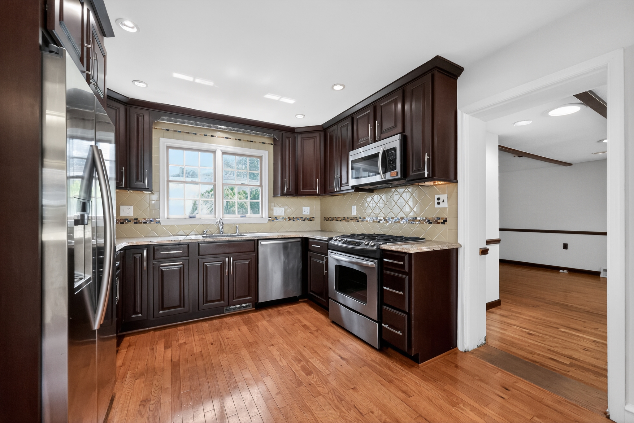 36 Decatur Road Havertown, PA 19083 - Photo 8 of 35 a kitchen with stainless steel appliances granite countertop a stove a sink and a refrigerator