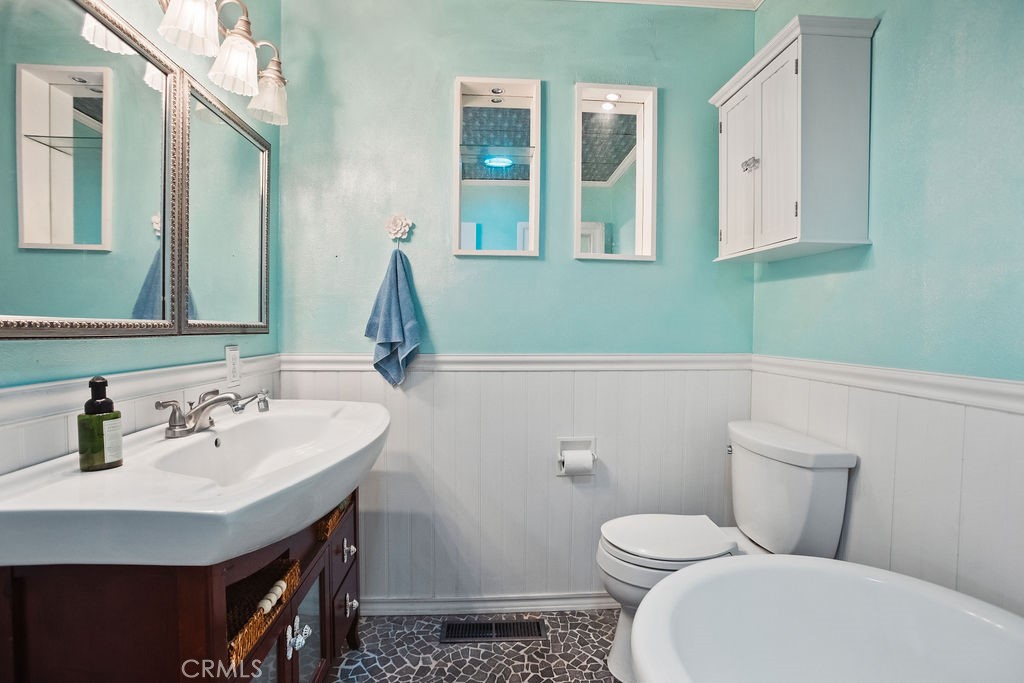 3046 El Capitan Avenue Merced, CA 95340 - Photo 11 of 18 a bathroom with a toilet sink and mirror