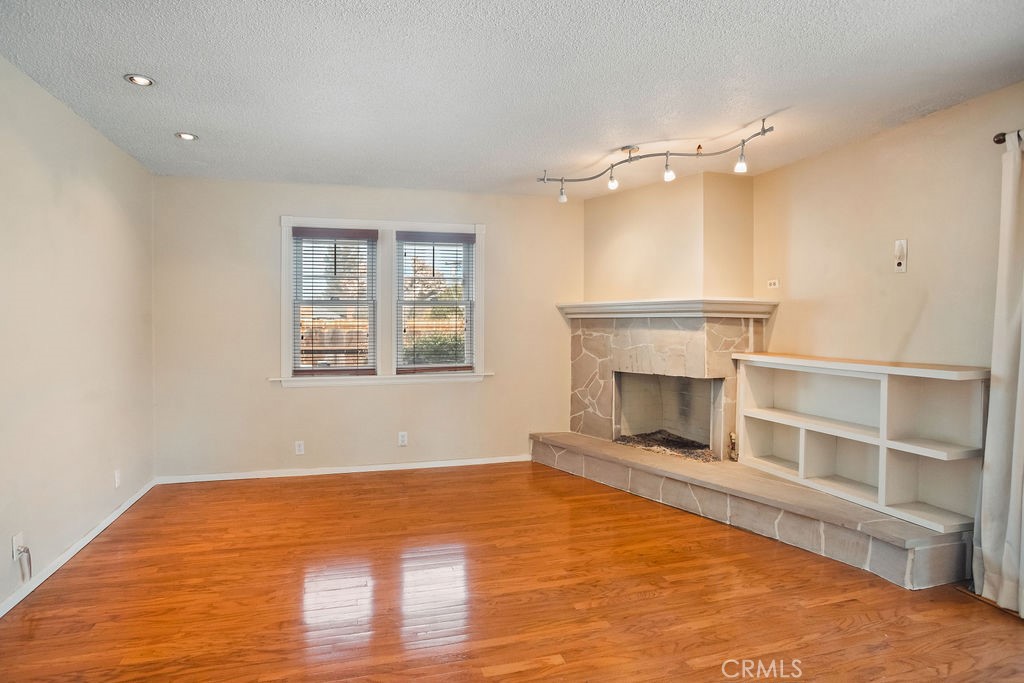 3046 El Capitan Avenue Merced, CA 95340 - Photo 7 of 18 a view of an empty room with a fireplace and a window